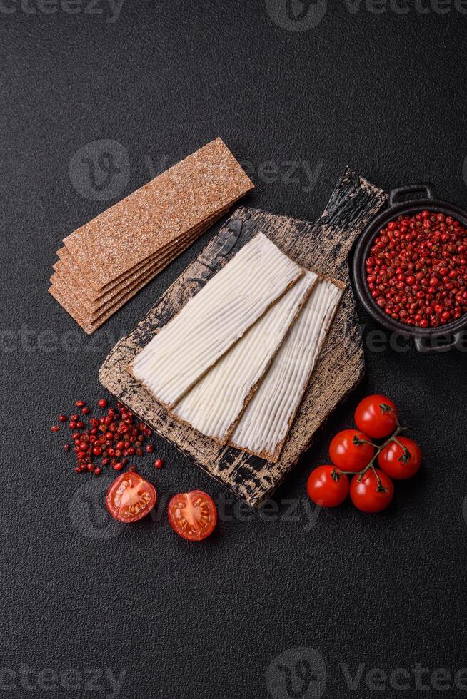 Rectangular whole grain crisp bread with cream cheese photo