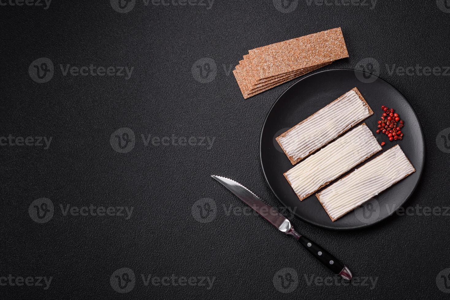 Rectangular whole grain crisp bread with cream cheese photo