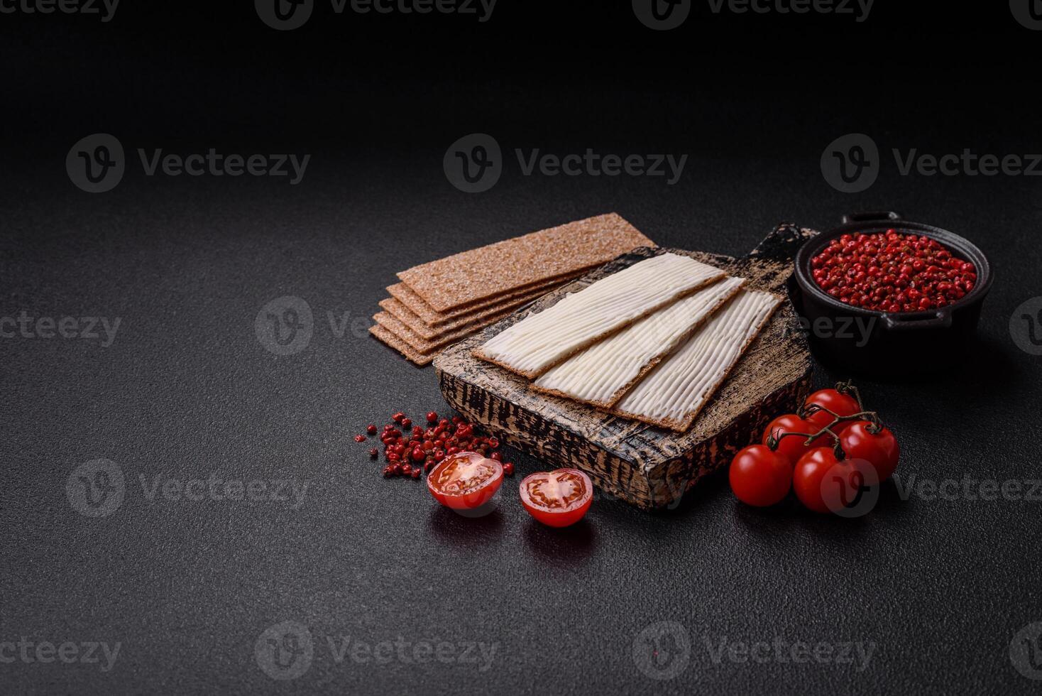Rectangular whole grain crisp bread with cream cheese photo
