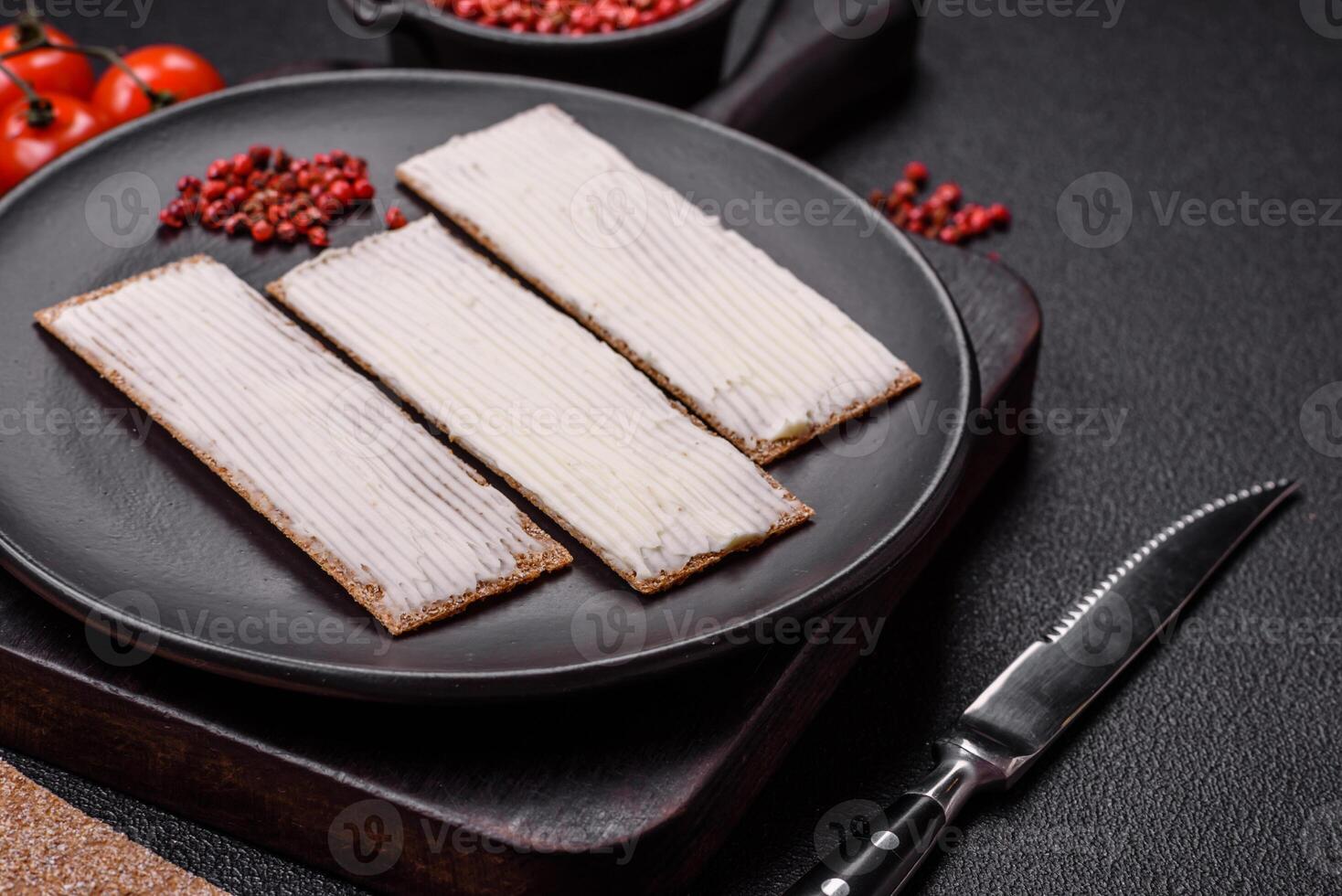 Rectangular whole grain crisp bread with cream cheese photo