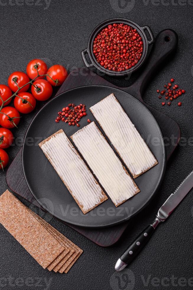 Rectangular whole grain crisp bread with cream cheese photo