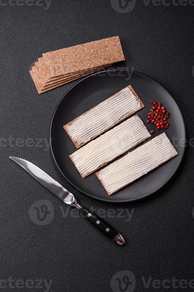 Rectangular whole grain crisp bread with cream cheese photo