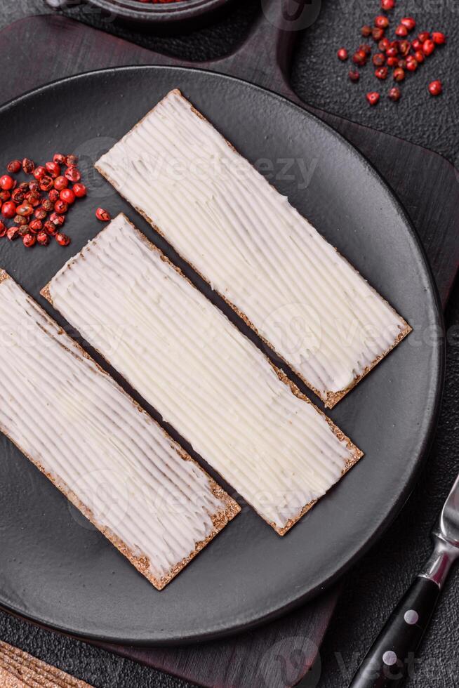Rectangular whole grain crisp bread with cream cheese photo
