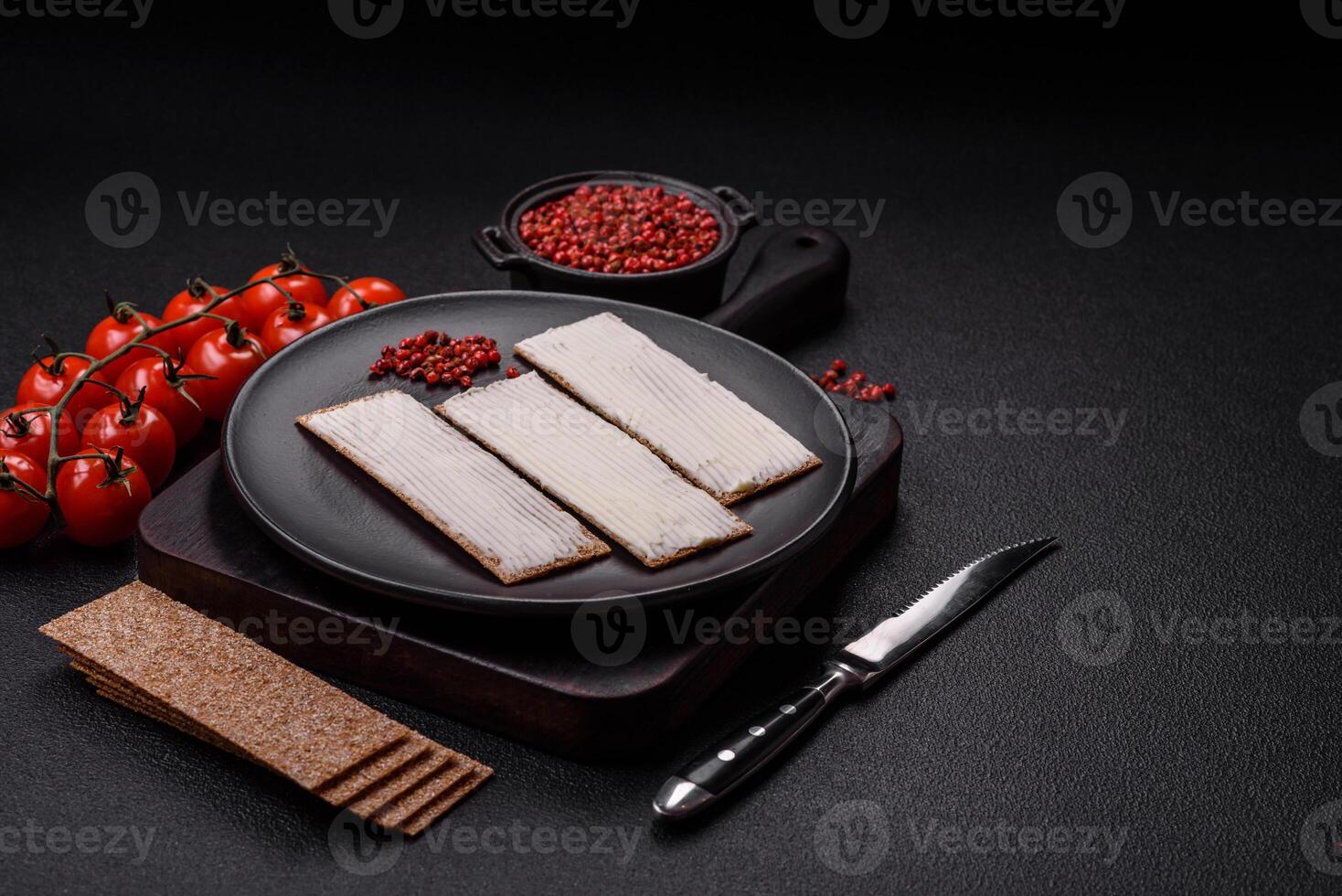Rectangular whole grain crisp bread with cream cheese photo
