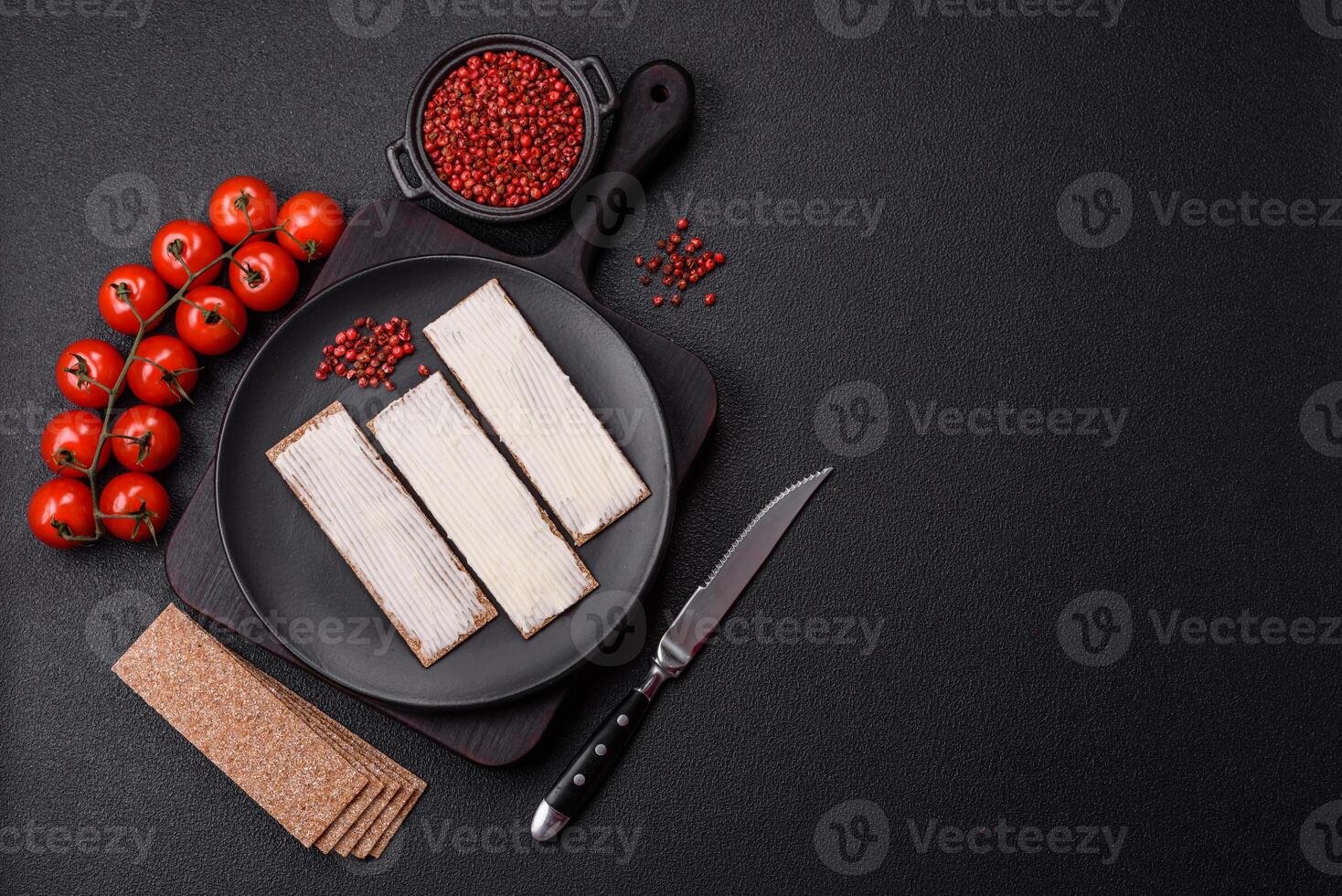 Rectangular whole grain crisp bread with cream cheese photo