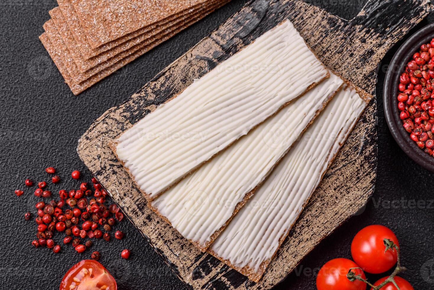 Rectangular whole grain crisp bread with cream cheese photo