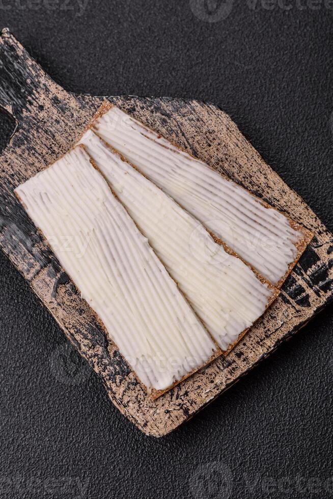 Rectangular whole grain crisp bread with cream cheese photo
