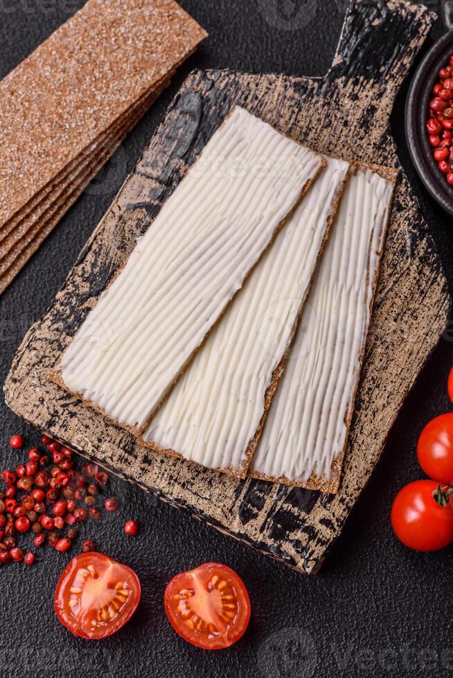 Rectangular whole grain crisp bread with cream cheese photo