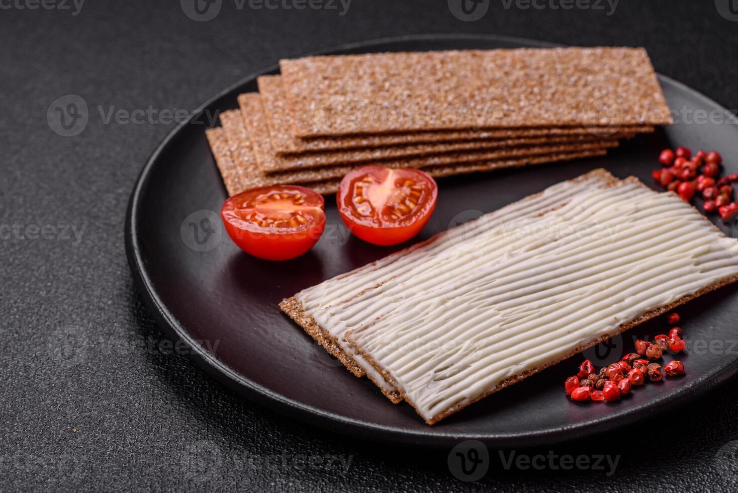 Rectangular whole grain crisp bread with cream cheese photo
