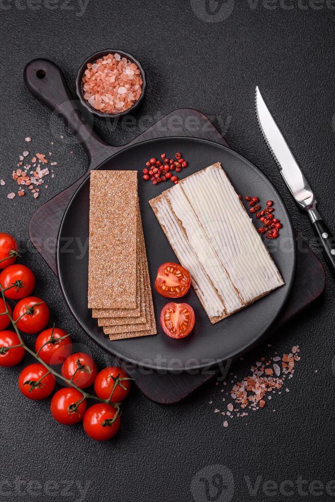 Rectangular whole grain crisp bread with cream cheese photo