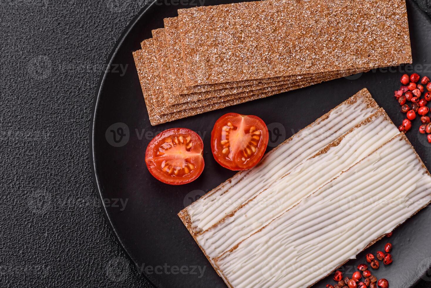 Rectangular whole grain crisp bread with cream cheese photo