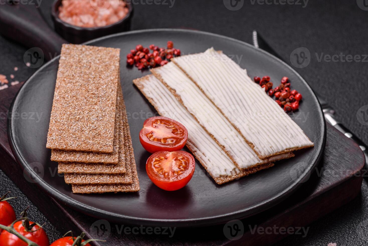 Rectangular whole grain crisp bread with cream cheese photo