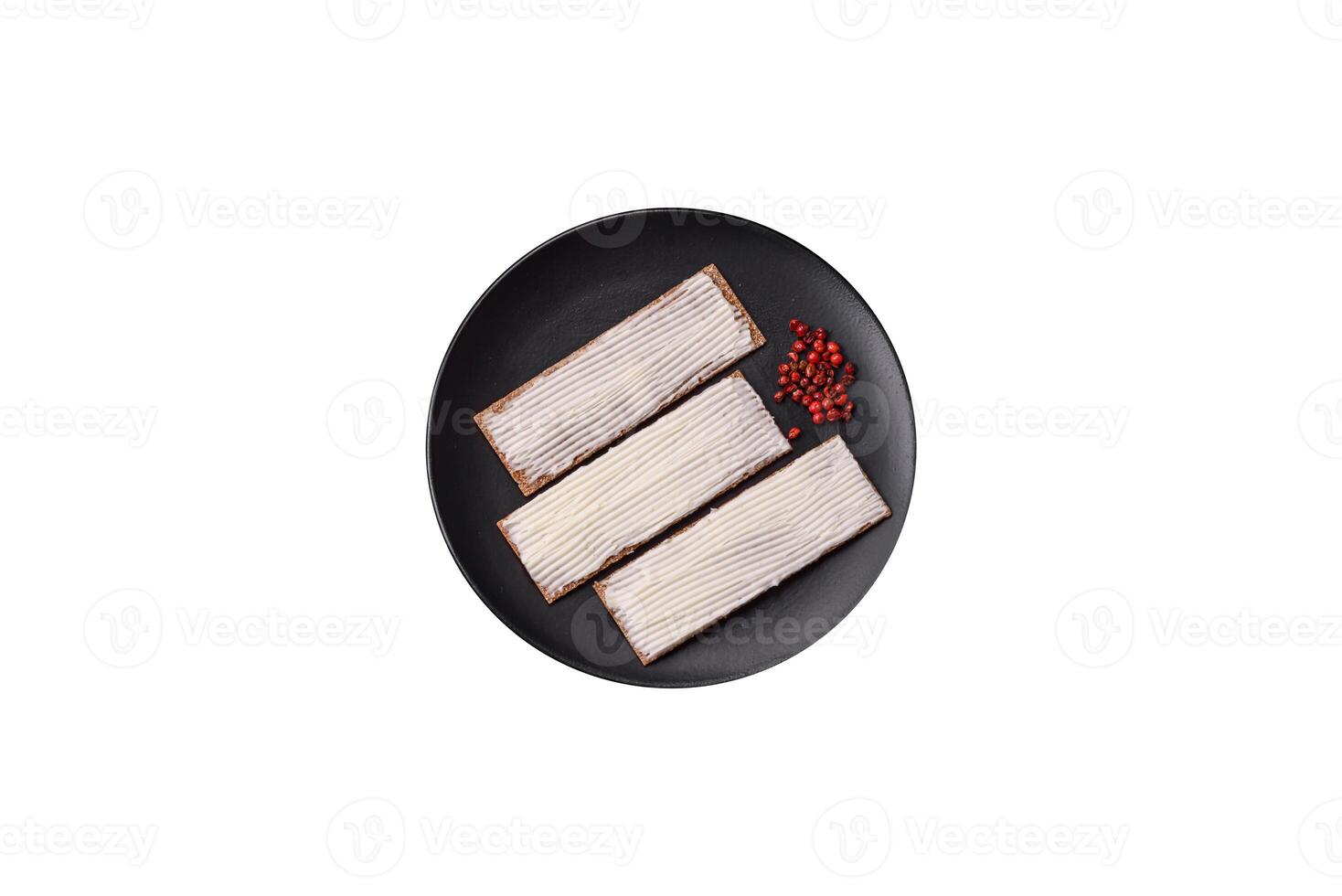 Rectangular whole grain crisp bread with cream cheese photo