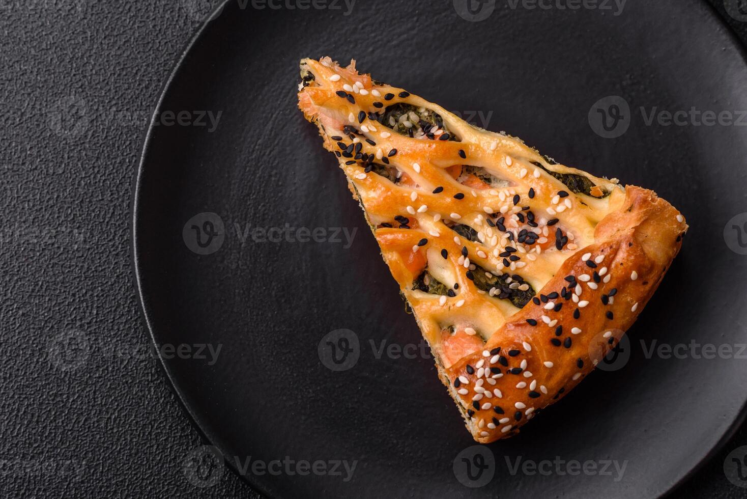 Pieces of quiche with salmon, spinach or broccoli, salt and spices photo