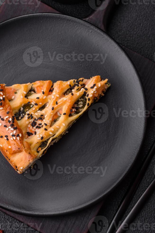 Pieces of quiche with salmon, spinach or broccoli, salt and spices photo