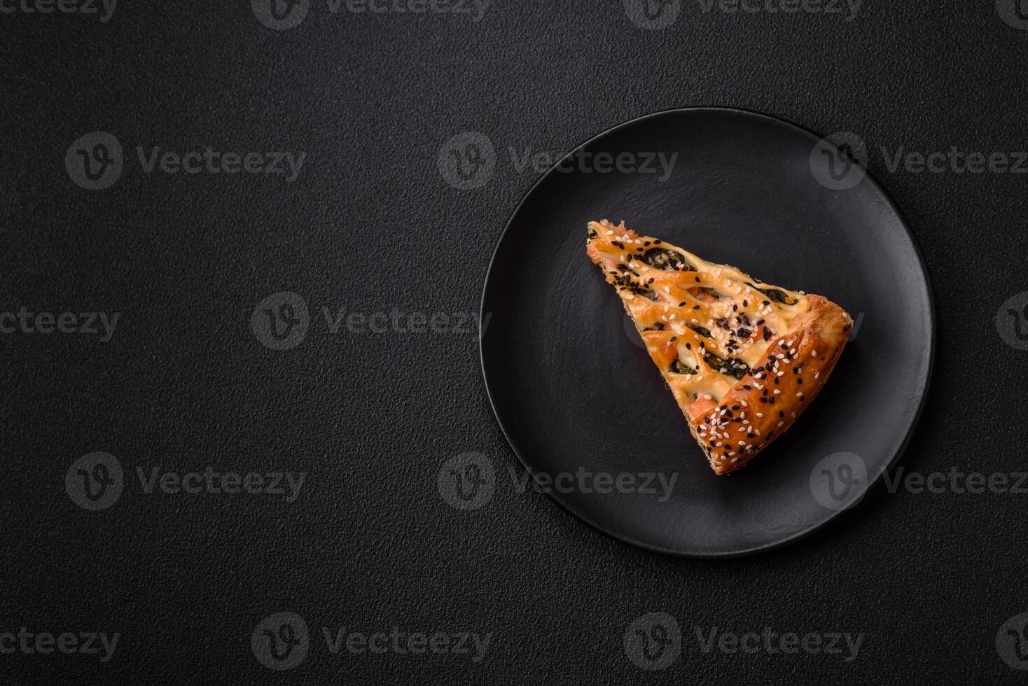 Pieces of quiche with salmon, spinach or broccoli, salt and spices photo