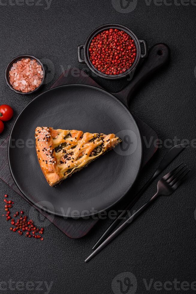 Pieces of quiche with salmon, spinach or broccoli, salt and spices photo