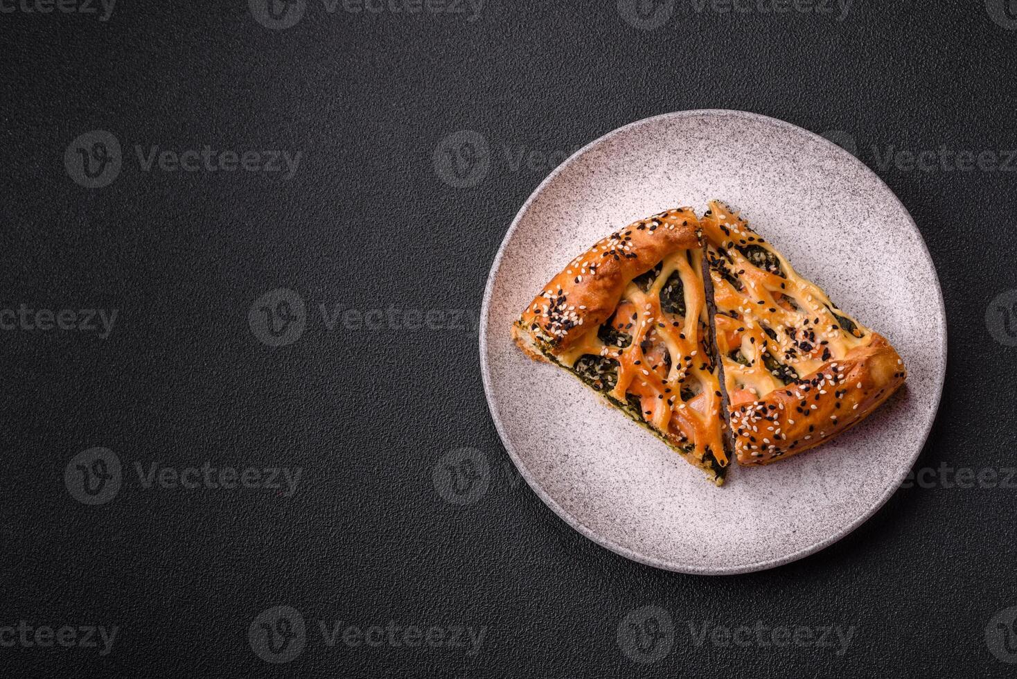 Pieces of quiche with salmon, spinach or broccoli, salt and spices photo