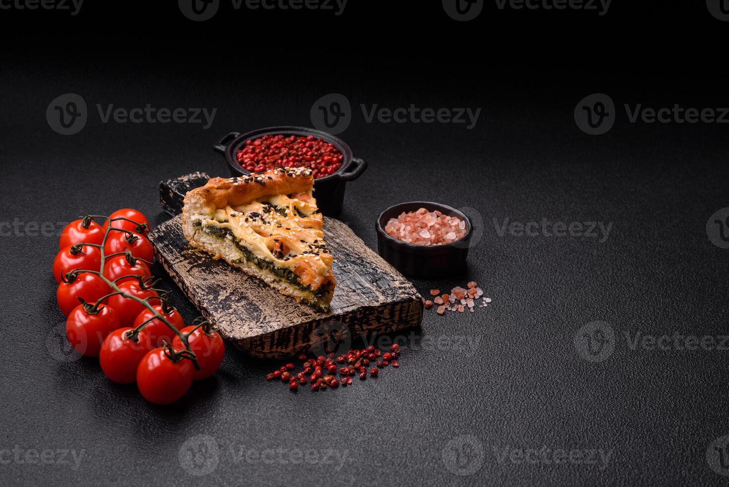 Pieces of quiche with salmon, spinach or broccoli, salt and spices photo