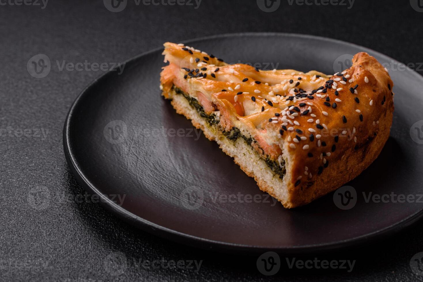 Pieces of quiche with salmon, spinach or broccoli, salt and spices photo