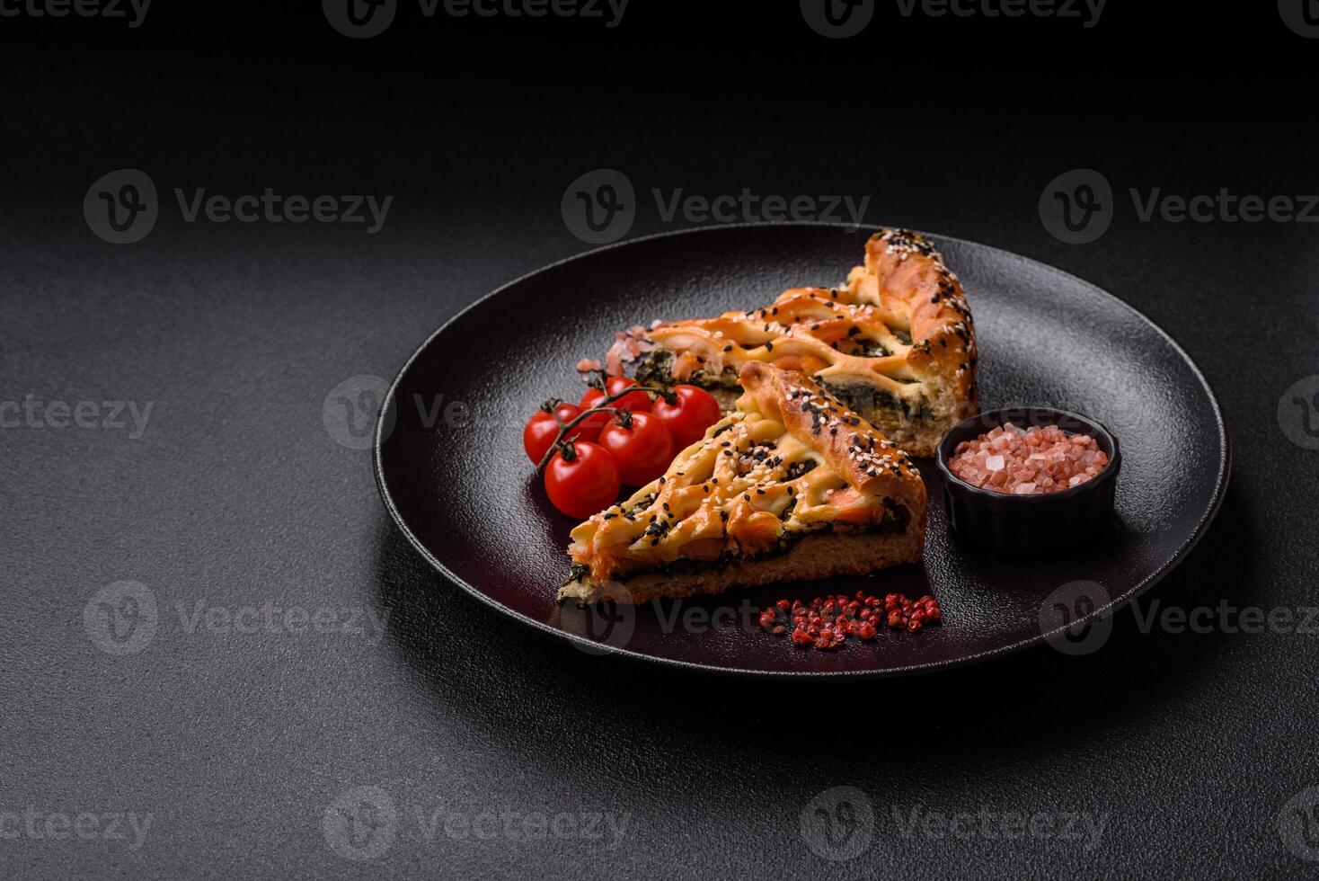 Pieces of quiche with salmon, spinach or broccoli, salt and spices photo