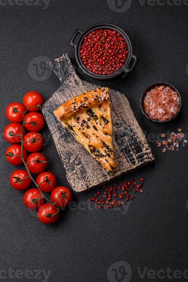 Pieces of quiche with salmon, spinach or broccoli, salt and spices photo