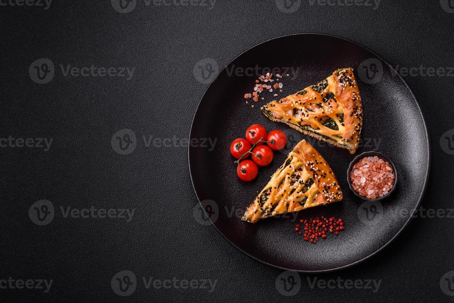 Pieces of quiche with salmon, spinach or broccoli, salt and spices photo