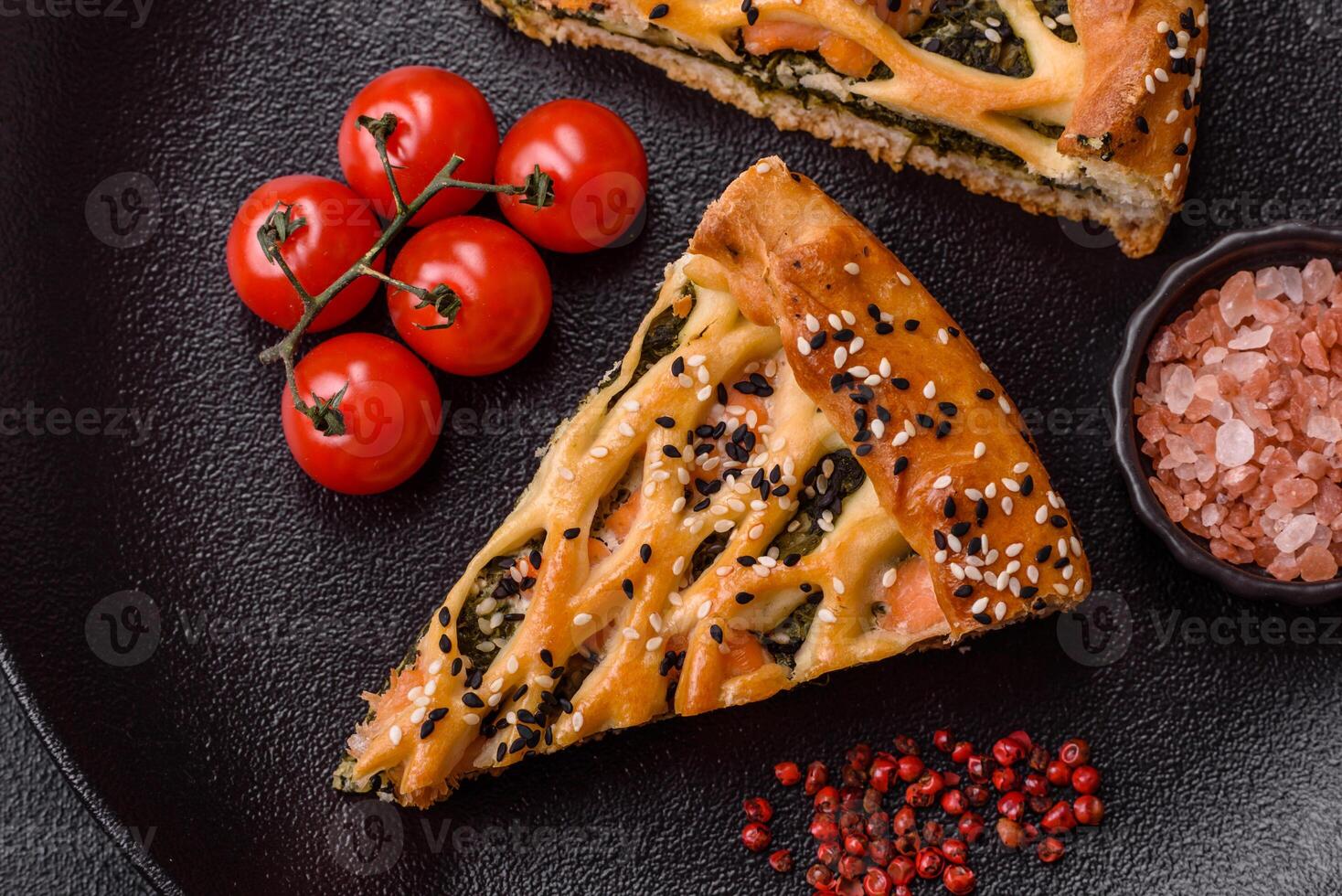 Pieces of quiche with salmon, spinach or broccoli, salt and spices photo