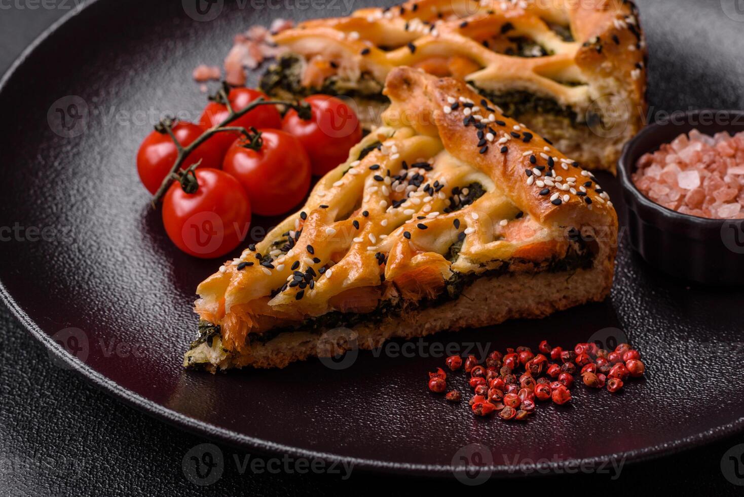 Pieces of quiche with salmon, spinach or broccoli, salt and spices photo