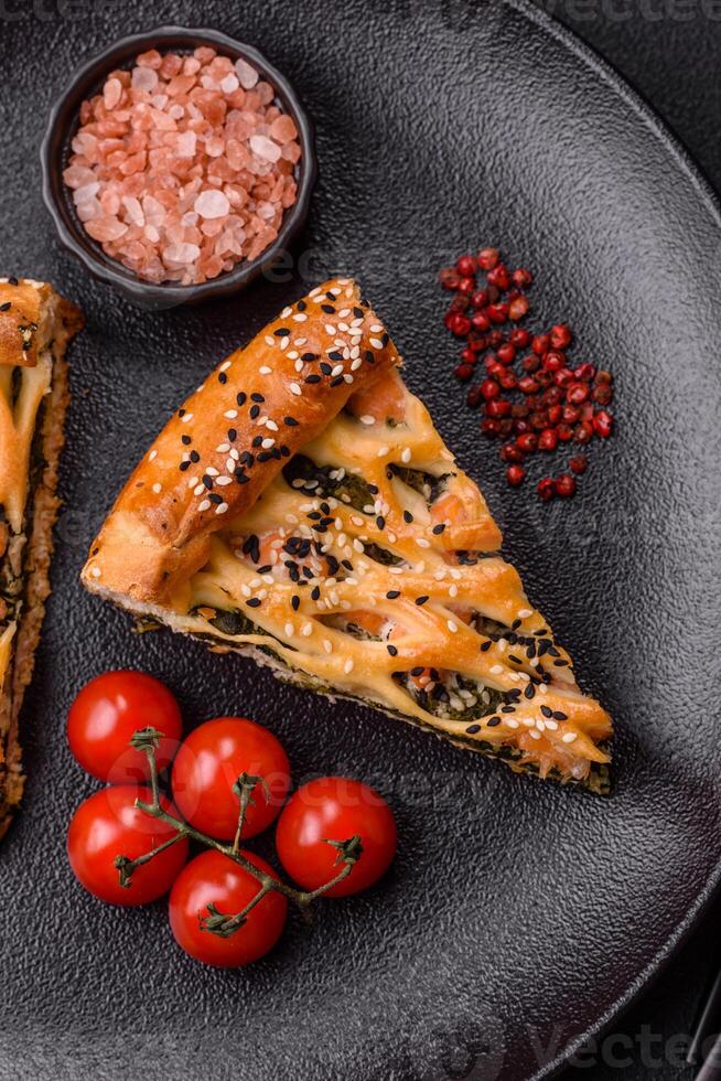 Pieces of quiche with salmon, spinach or broccoli, salt and spices photo