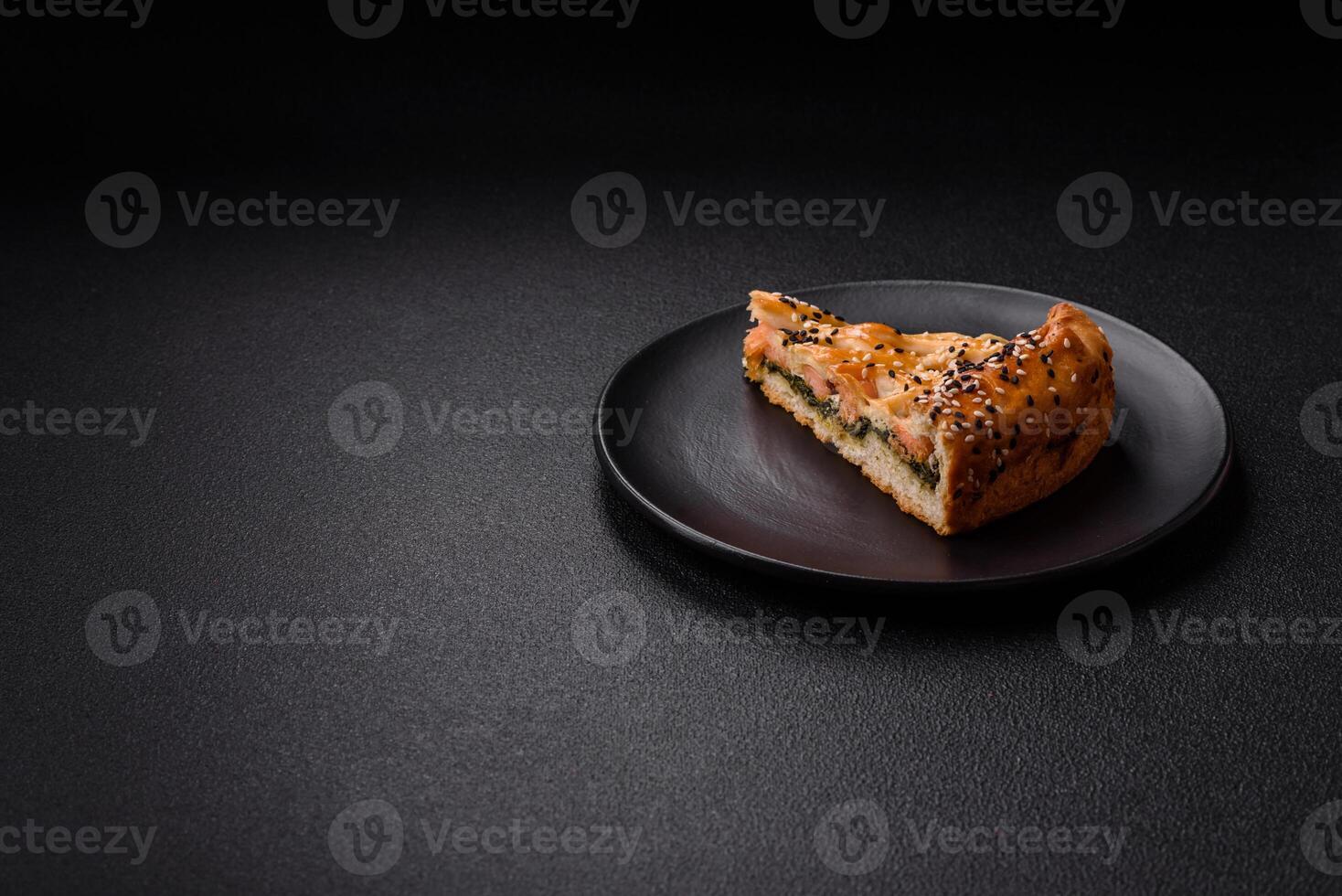 Pieces of quiche with salmon, spinach or broccoli, salt and spices photo