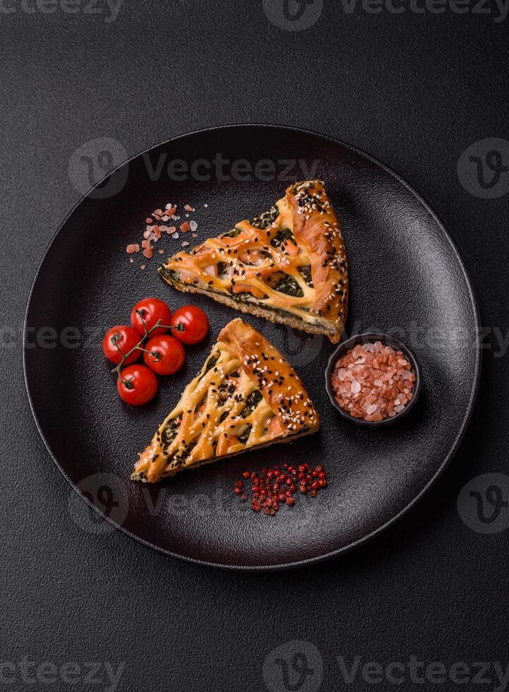 Pieces of quiche with salmon, spinach or broccoli, salt and spices photo