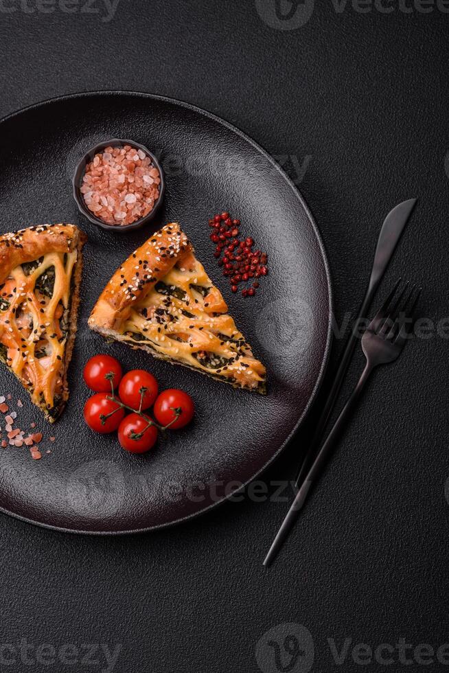 Pieces of quiche with salmon, spinach or broccoli, salt and spices photo