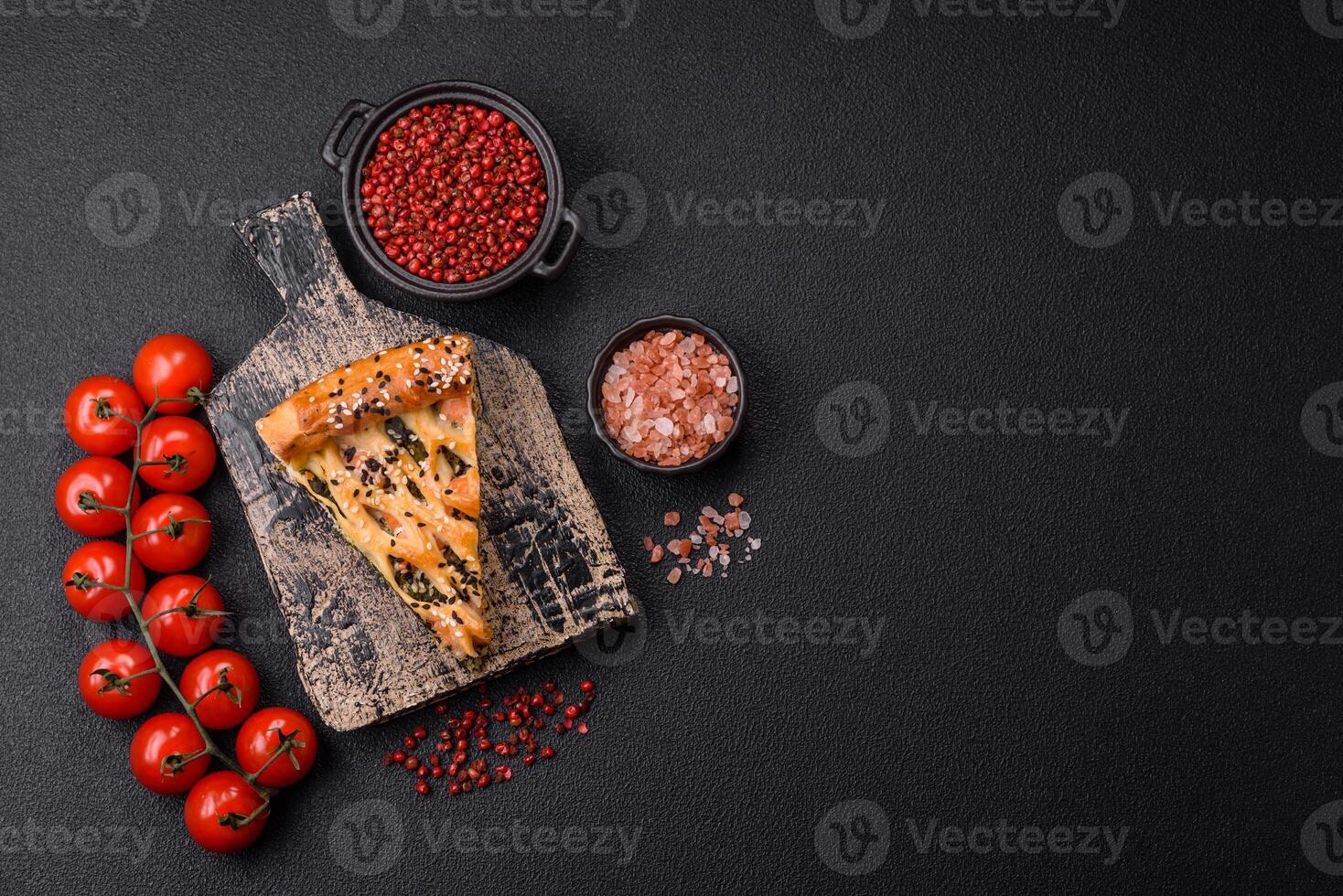 Pieces of quiche with salmon, spinach or broccoli, salt and spices photo