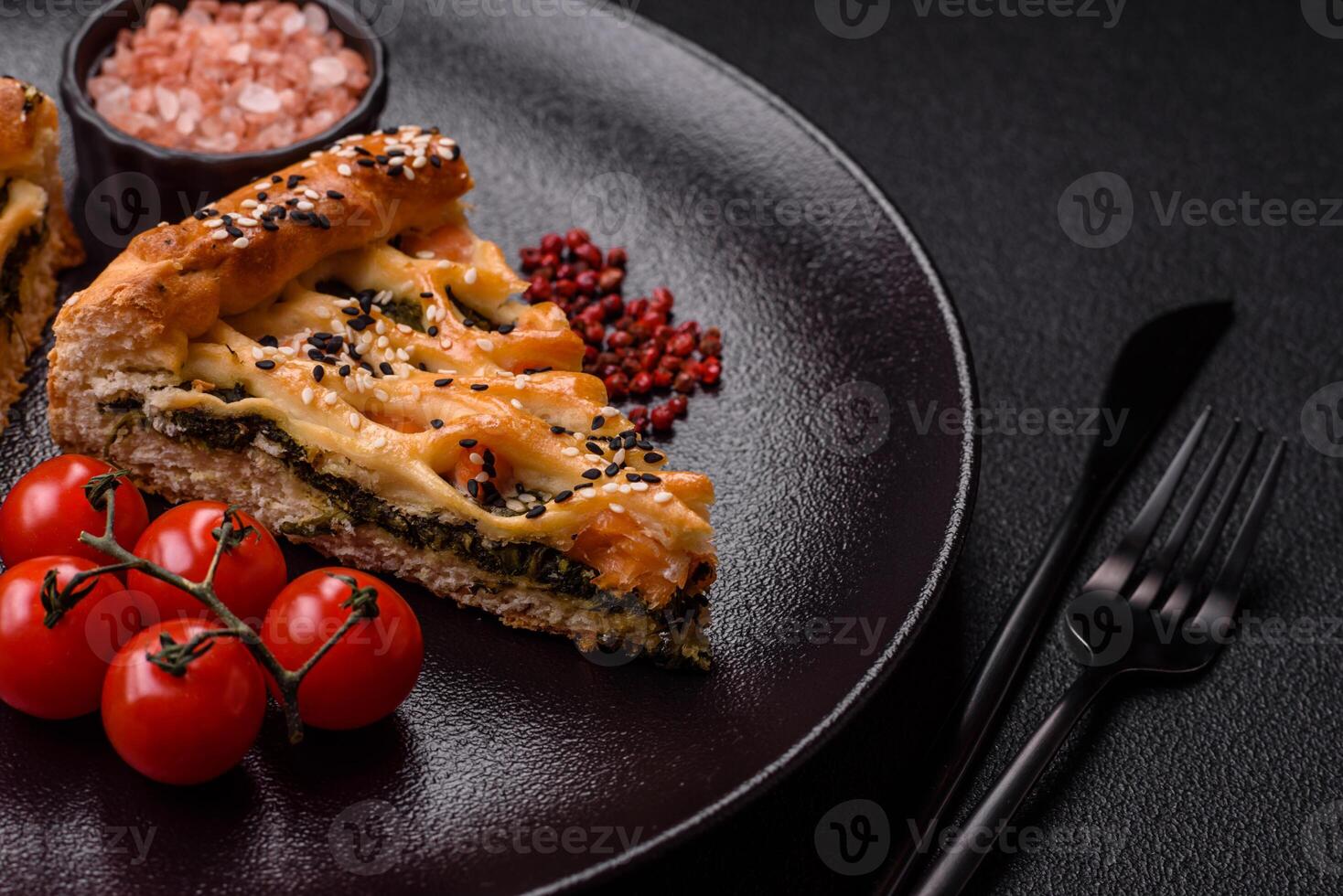 Pieces of quiche with salmon, spinach or broccoli, salt and spices photo