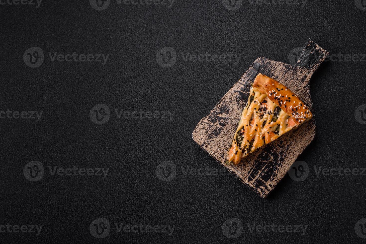 Pieces of quiche with salmon, spinach or broccoli, salt and spices photo
