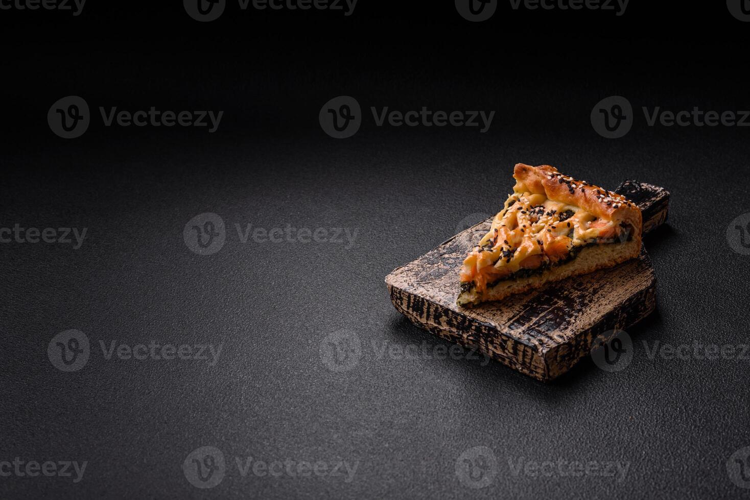 Pieces of quiche with salmon, spinach or broccoli, salt and spices photo
