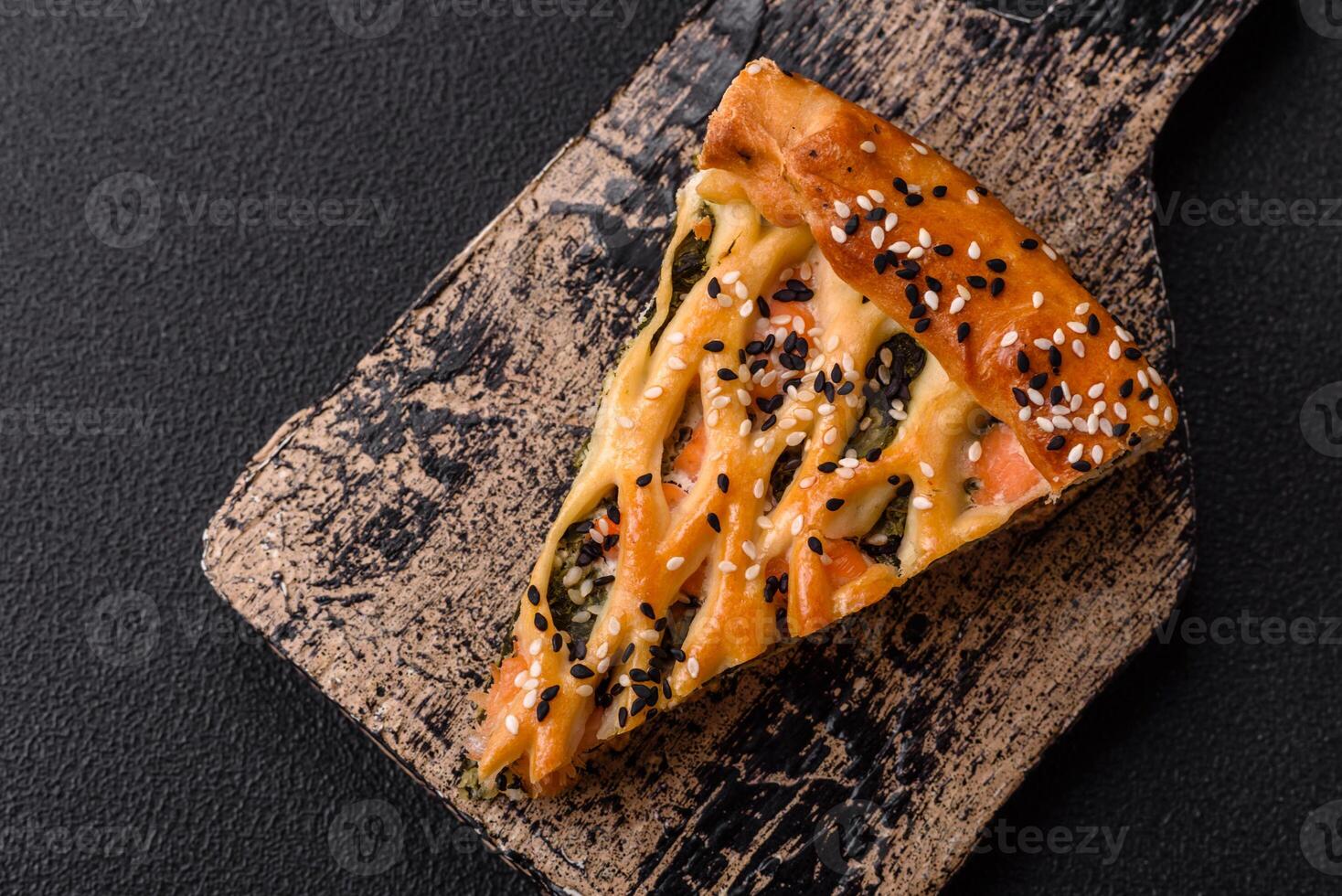 Pieces of quiche with salmon, spinach or broccoli, salt and spices photo