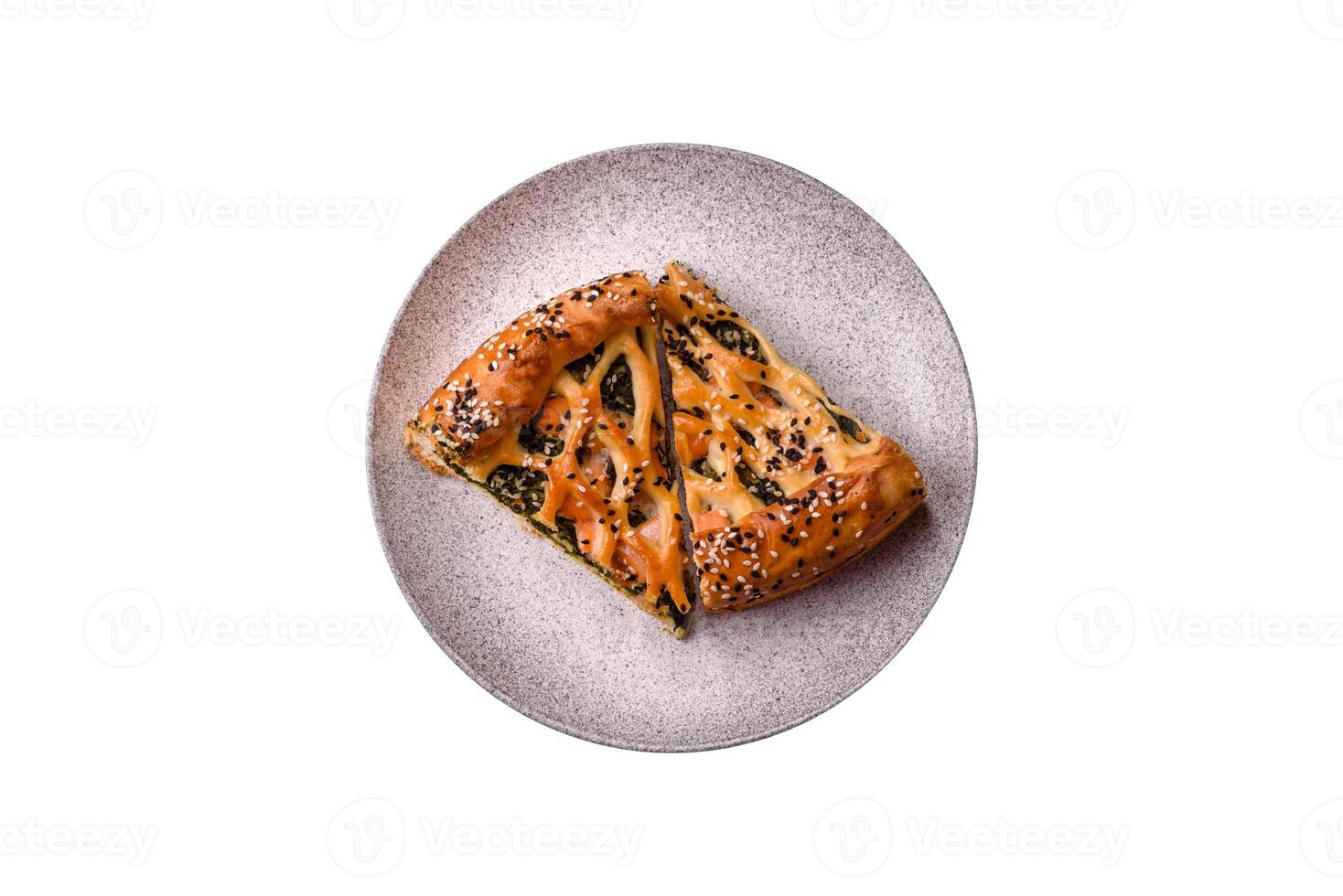 Pieces of quiche with salmon, spinach or broccoli, salt and spices photo