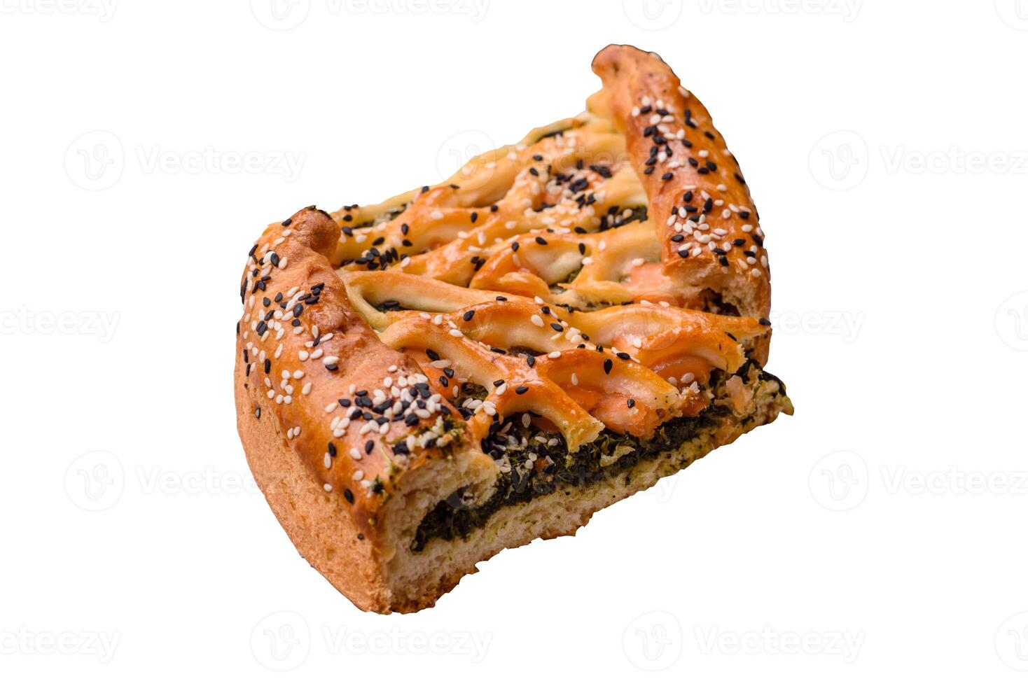 Pieces of quiche with salmon, spinach or broccoli, salt and spices photo