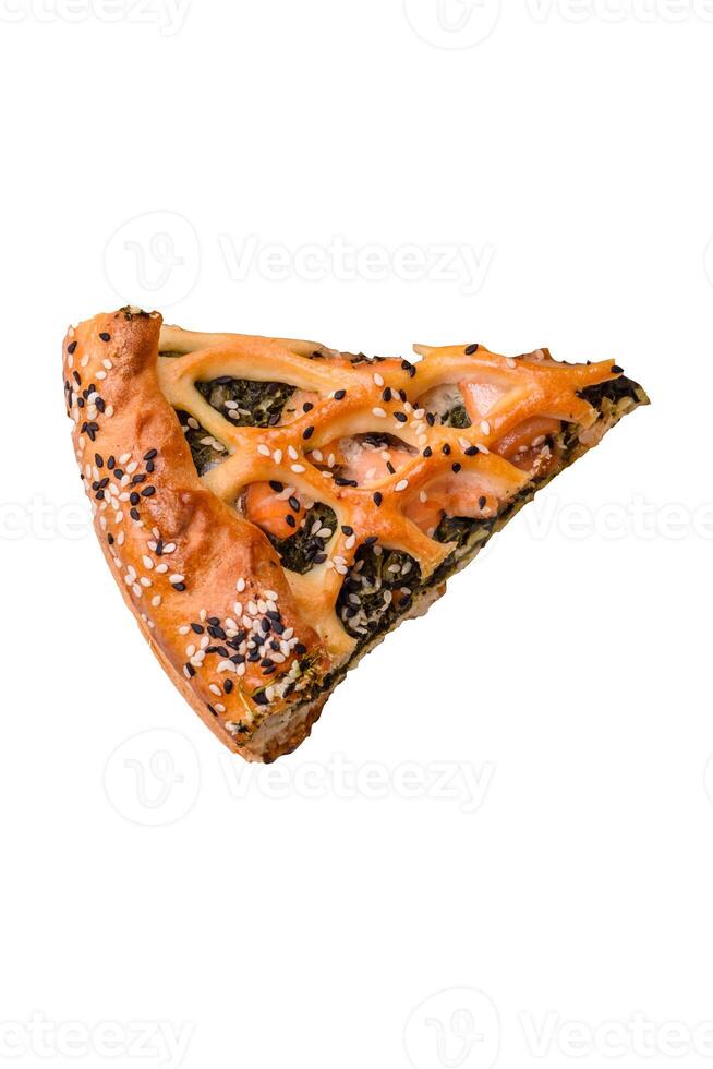 Pieces of quiche with salmon, spinach or broccoli, salt and spices photo