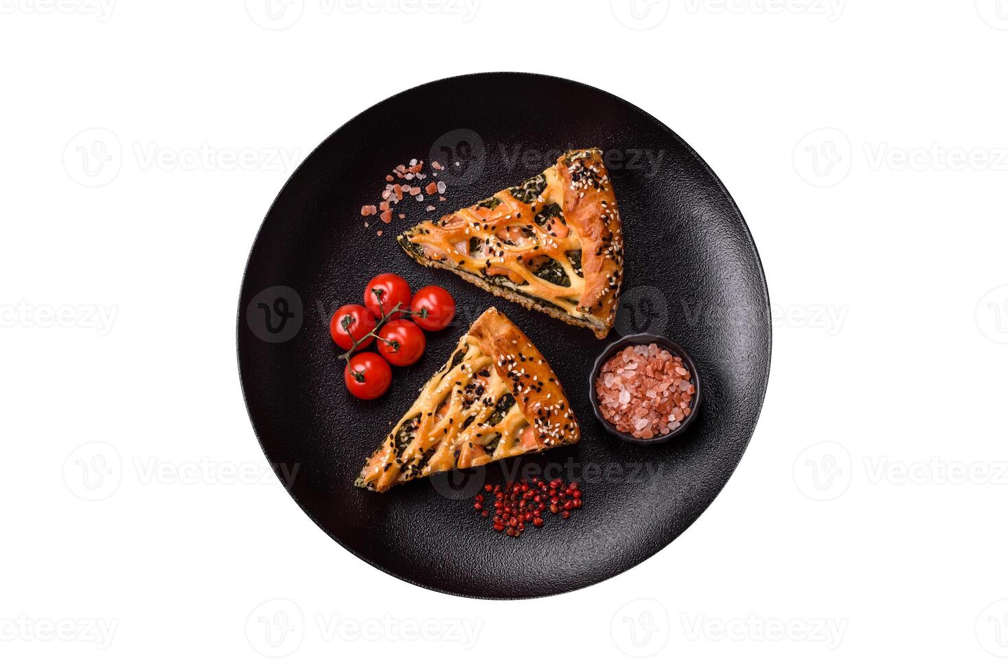 Pieces of quiche with salmon, spinach or broccoli, salt and spices photo