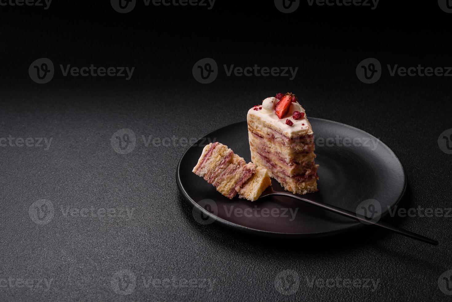 Piece of sweet layer cake with white cream, raspberries and strawberries photo