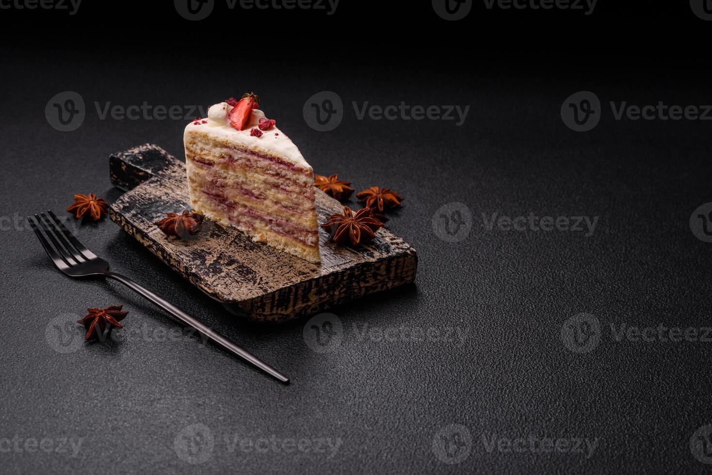 Piece of sweet layer cake with white cream, raspberries and strawberries photo