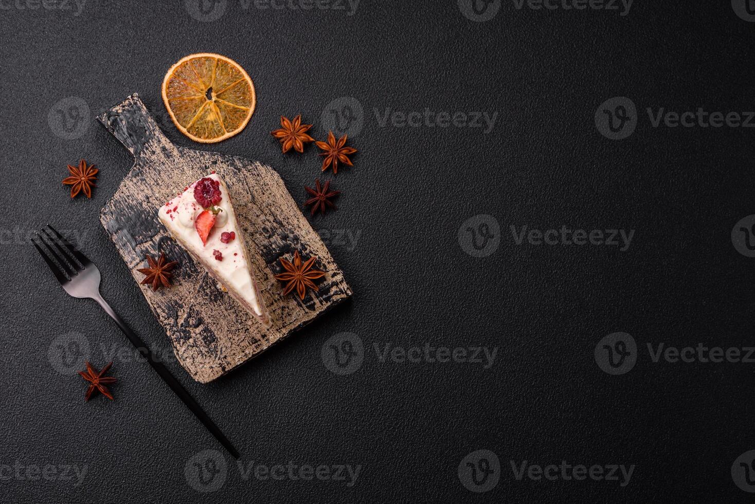 Piece of sweet layer cake with white cream, raspberries and strawberries photo