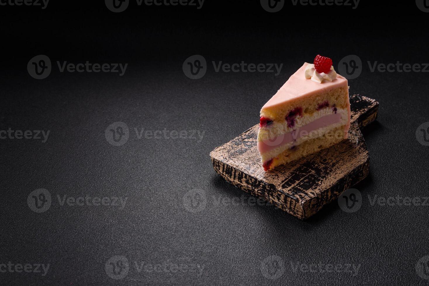 Piece of sweet cake with pink cream with raspberry flavor, with shortbread, cheesecake photo