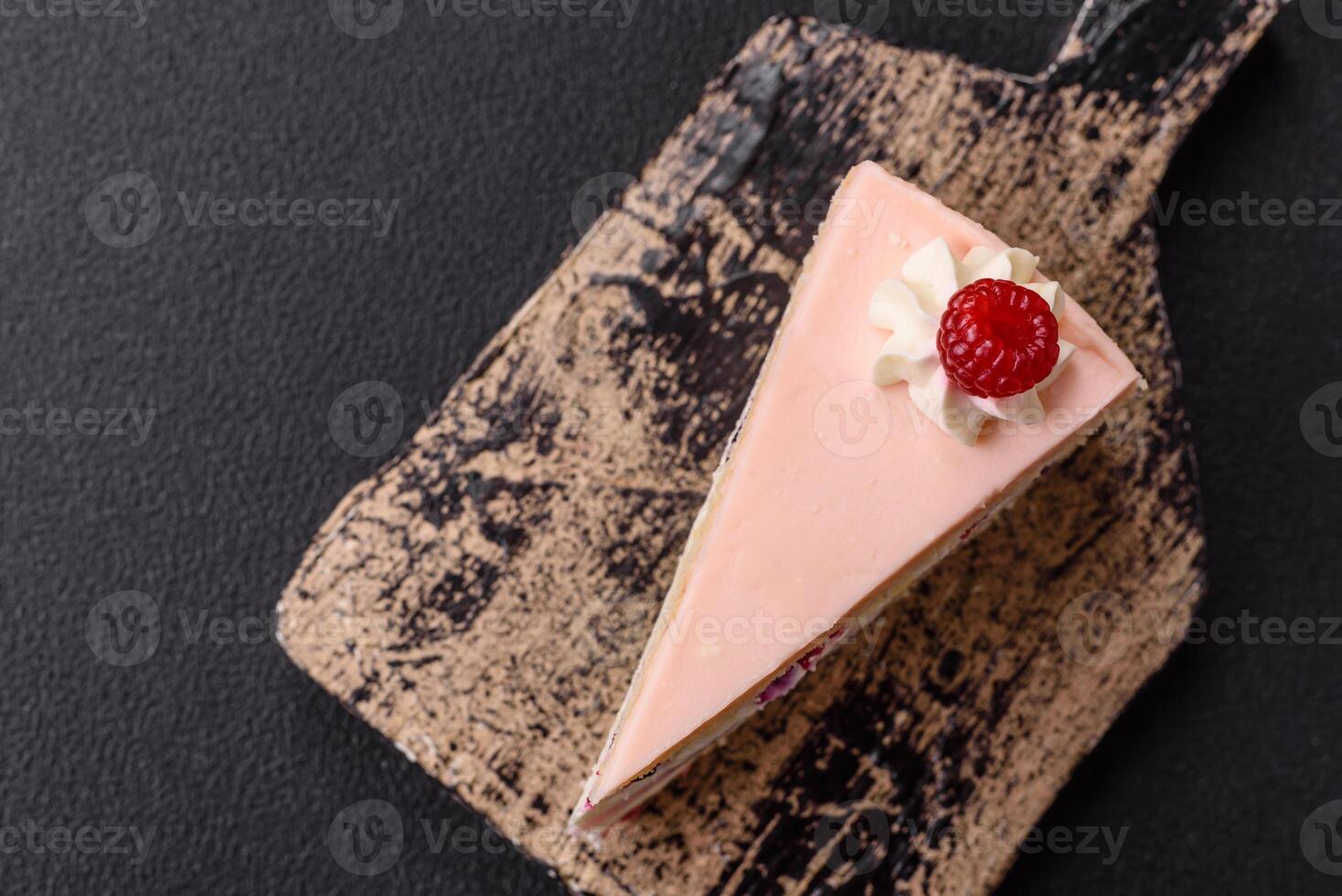 Piece of sweet cake with pink cream with raspberry flavor, with shortbread, cheesecake photo