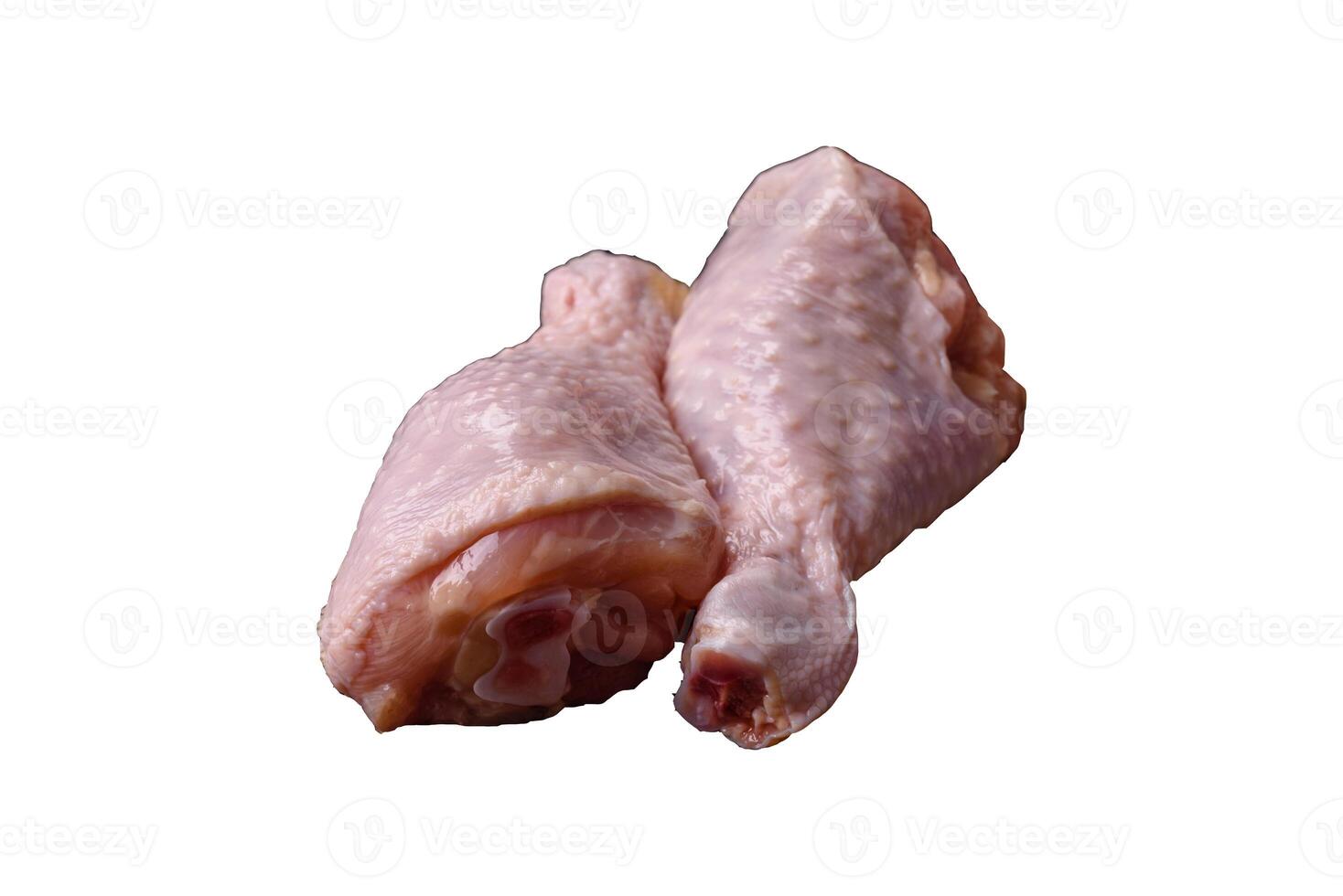 Raw chicken legs with salt, spices, herbs and tomatoes photo