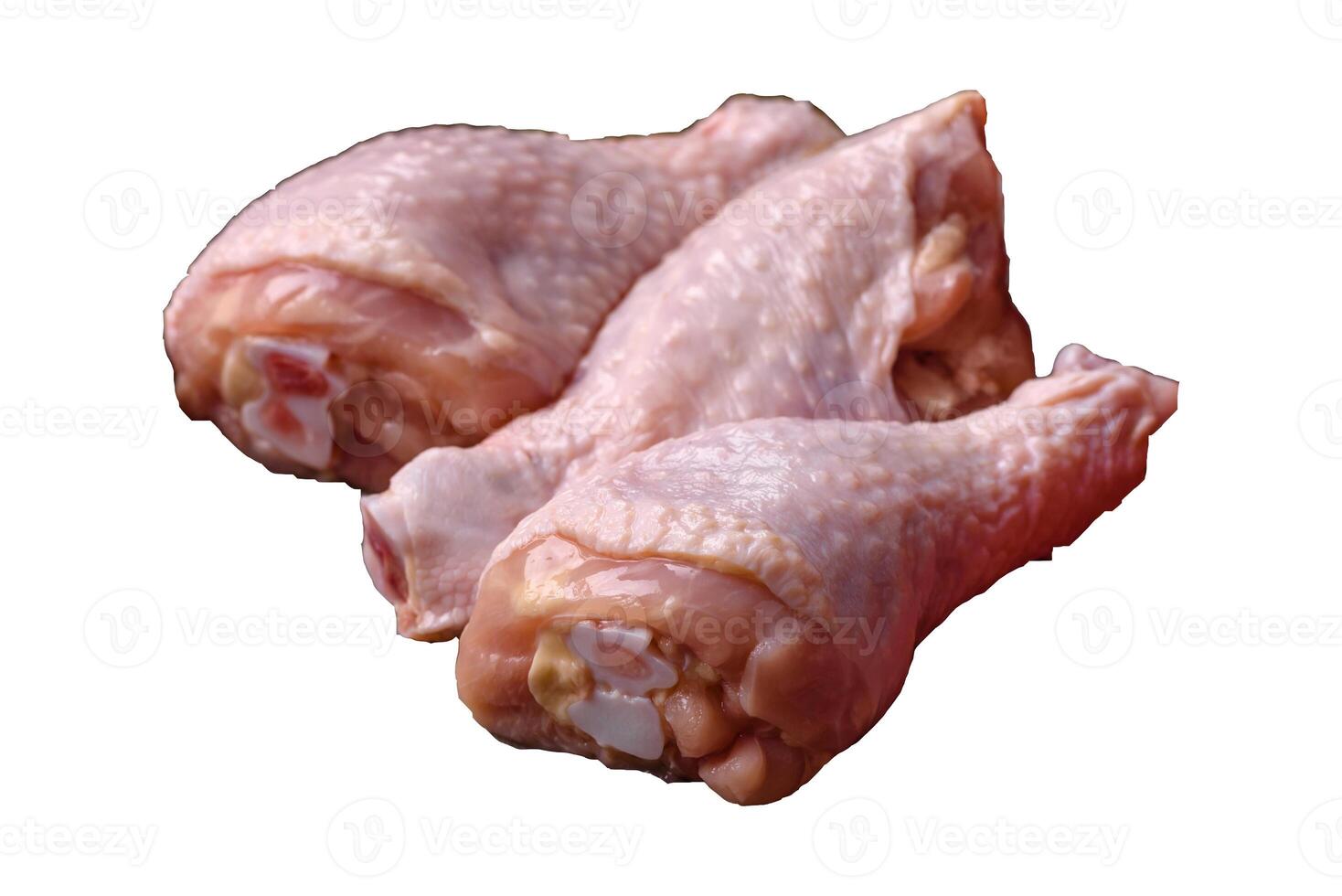 Raw chicken legs with salt, spices, herbs and tomatoes photo