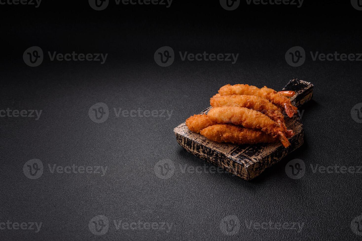 Hot crispy shrimp breaded with salt and spices with white sauce photo